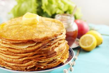 pile of thin pancakes on a plate