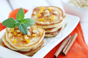 Fried pancakes with dried apricots and pine nuts