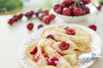 pancakes with jam, cherry and pine nuts