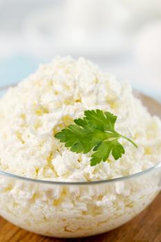 Cottage cheese in a transparent  bowl with parsley