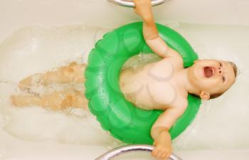 girl singing in the bath, a lying on the inflatable circle