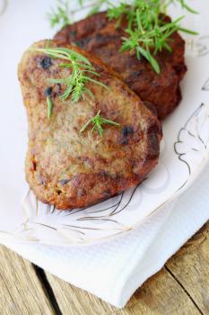 Pork schnitzel with fresh savory on plate