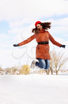 woman jumping up in the winter outdoors