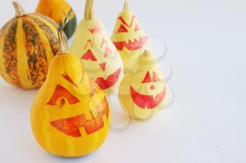 Small decorative pumpkins with a painted face