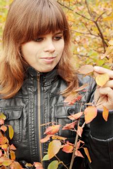 Portrait of a beautiful young woman in autumn park