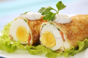pancake stuffed with egg and salmon with sour cream