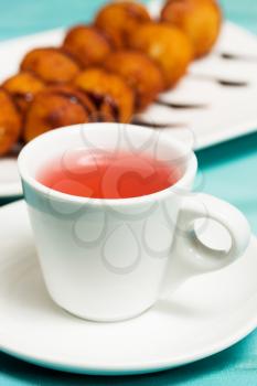 A cup of tea with hibiscus and cheese balls