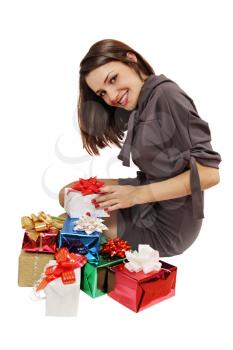 beautiful woman sits near a pile of gifts