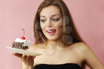 Young beautiful woman with a cake on a plate