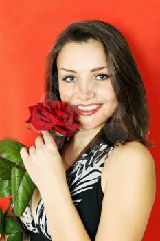 Woman with rose on a red background 