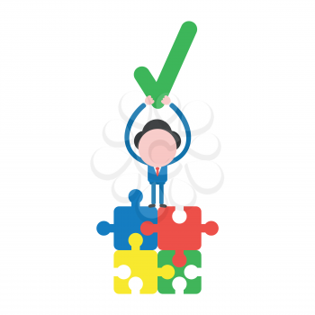 Vector illustration businessman character standing on four connected jigsaw puzzle pieces and holding up check mark.