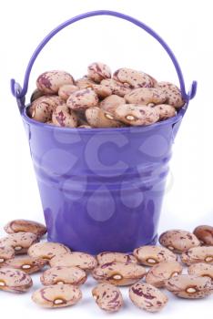 Pail with beans on a white background.