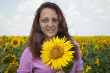 Beautiful girl in a field of sunflowers.