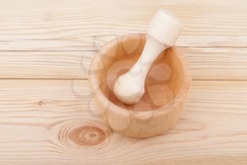 Wooden mortar with pestle.