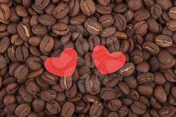Two hearts on coffee beans.