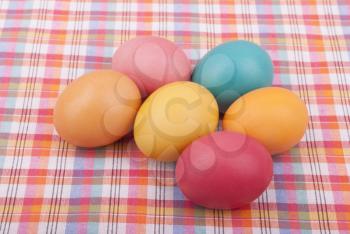 Easter colored eggs on the tablecloth.