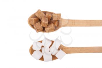 Refined sugar in the spoons on a white background.