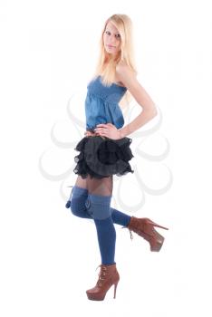 Blonde in a dress playfully posing on a white background.