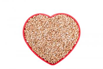 Buckwheat in a bowl in the shape of heart.