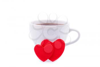 Cup of coffee and two red hearts on a white background.