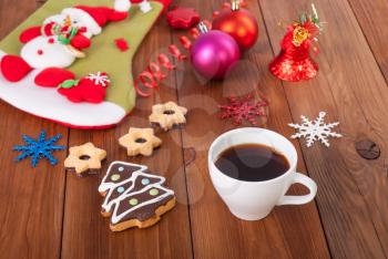 Cup of coffee cookies Christmas toy on a wooden table.