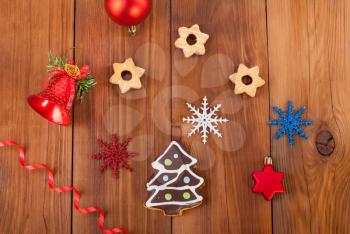 Gingerbread cookies and Christmas balls on wooden table.
