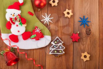 Christmas toys and cookies on a wooden background.