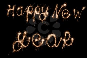Happy New Year sign sparklers on dark background.