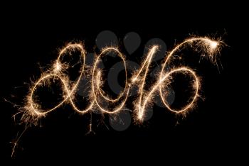 Happy New Year 2016 inscription sparklers on a black background .