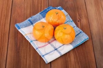 Mandarins on a wooden table.