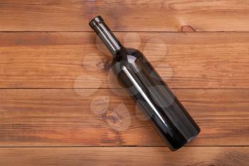 Bottle of wine on a wooden background. View from above .