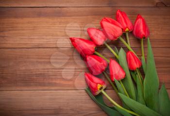 Bouquet of tulip on a wooden background.