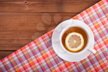 Tea with lemon on a kitchen table.