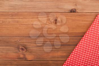 Red checkered cloth on a wooden table.