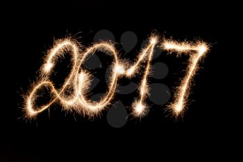 2017 written in sparklers on black background. Happy New Year !