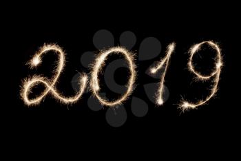 Happy New Year 2019 inscription sparklers on a black background.
