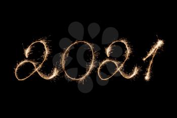 2021 New Year inscription with sparklers on a black background.