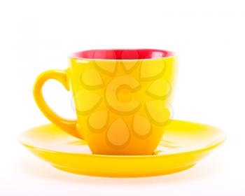 Beautiful color yellow cup mug on plate dish isolated on white background