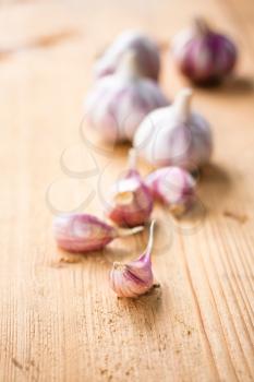Healthy organic garlic vegetables whole and cloves on the wooden background