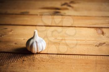 White raw garlic on wooden plank desk background