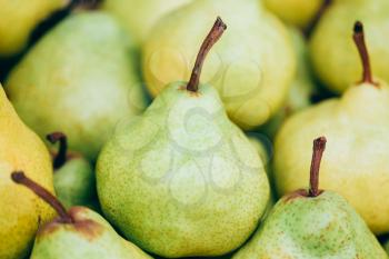 Green And Yellow Ripe Pears At A Farmers Market. Fruits Background