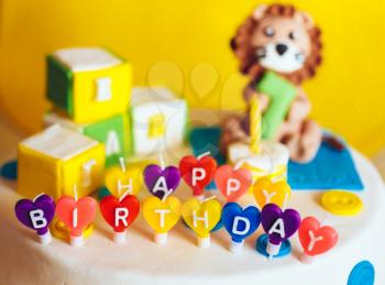 Happy Birthday Written In Candles On Colorful Cake Background