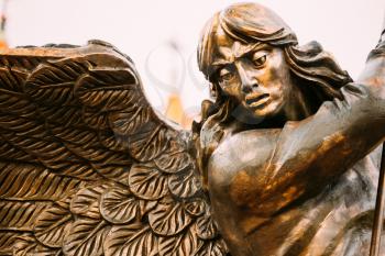 Close Up Detail Of Statue Of Archangel Michael With Outstretched Wings, Thrusting Spear Into Dragon Before Red Catholic Church Of St. Simon And St. Helena On Independence Square In Minsk, Belarus
