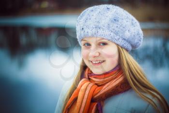 Teen Girl Wearing White Beret And Orange Scarf In Windy Day