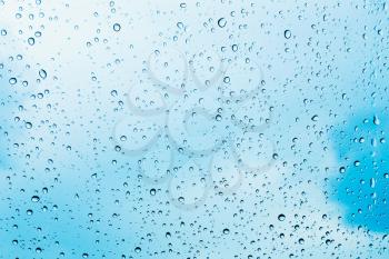 Water Drops Of Rain On Blue Glass Background