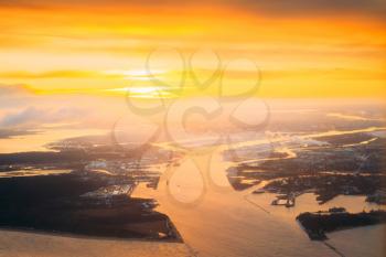 Western Dvina Flows Into The Baltic Sea. River Divides The Northern And Kurzeme District Of Riga, Latvia. View From Airplane Flight. Sunset Sunrise Over Gulf Of Riga, Bay Of Riga, Or Gulf Of Livonia