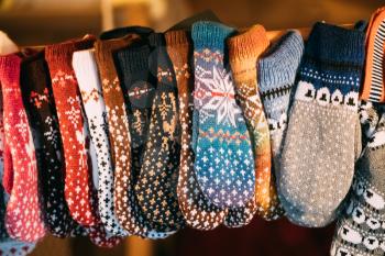 Close View Of Various Colorful Knitted Traditional European Warm Clothes - Mittens At Winter Christmas Market. Souvenir From Europe.