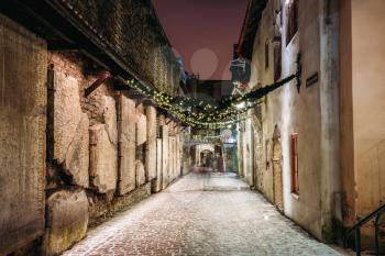 Tallinn, Estonia. Ancient Tombstones In St. Catherine's Passage From St. Catherine's Dominican Monastery At Night. Historic Centre Old Town Of Tallinn. UNESCO World Heritage Site