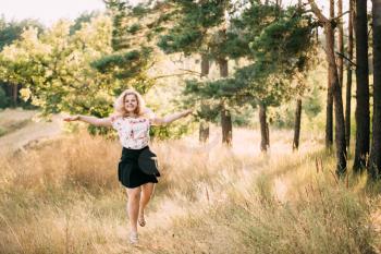 Single Young Pretty Plus Size Caucasian Happy Smiling Laughing Girl Woman In White T-Shirt, Dancing In Summer Green Forest. Fun Enjoy Outdoor Summer Nature.