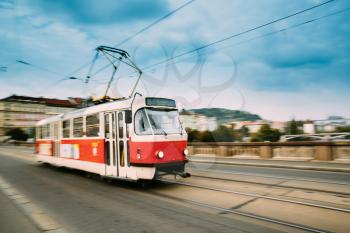 Prague, Czech Republic. Public Old Retro Tram Moving On Bridge Street In Blurred Motion